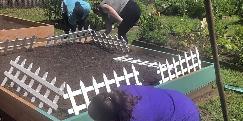 Painting raised beds in the Community Garden