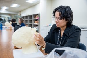 A Funeral Service student practices facial reconstruction techniques at Goodwin University.