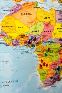 A close-up image of Africa on a globe with various locations marked by pinpoints.