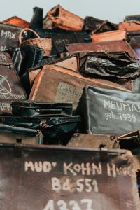A pile of assorted bags and boxes with names printed on them