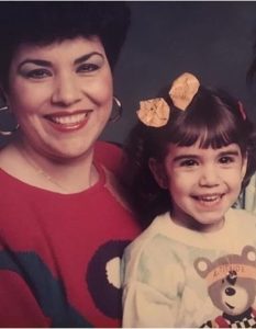 A portrait of a smiling woman and a young girl