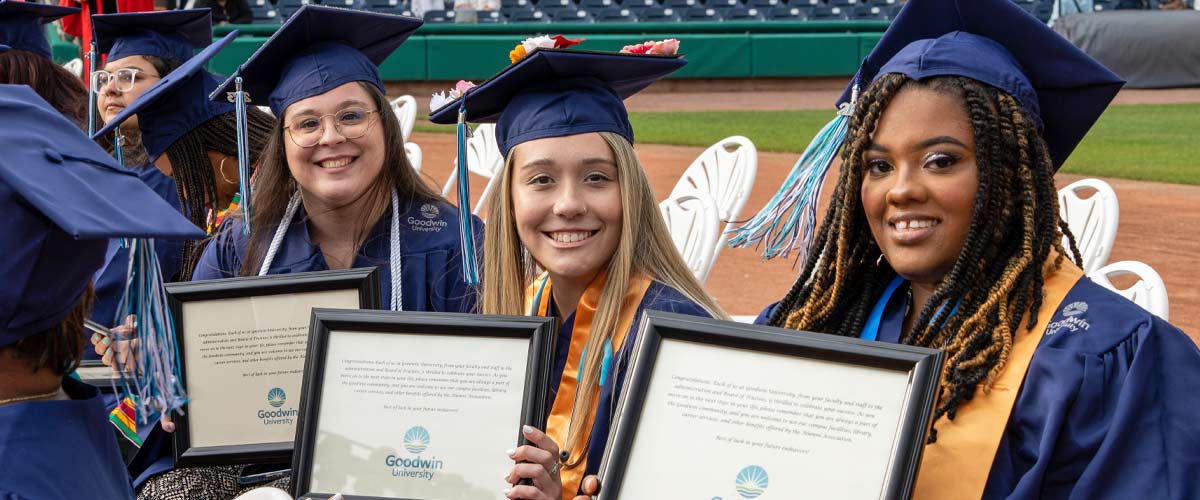 two female graduates smiling