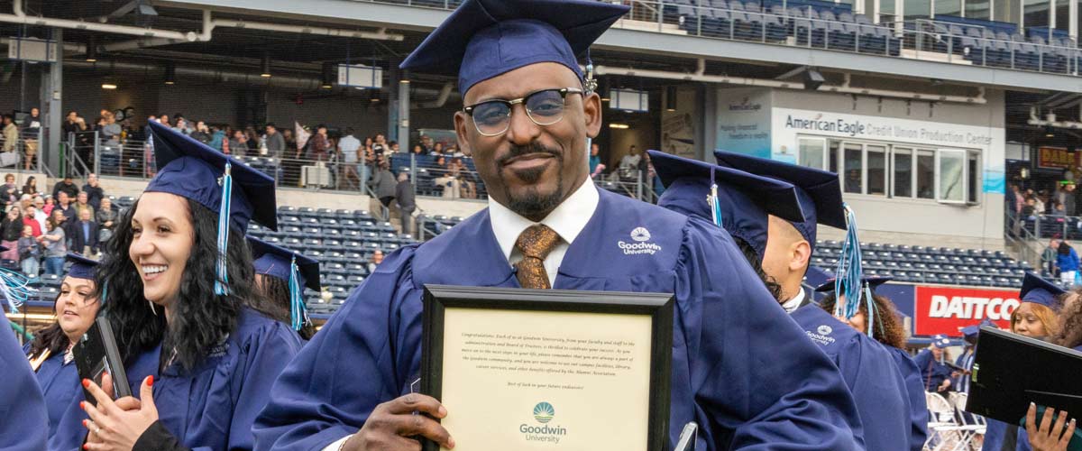 happy graduate holding up diploma