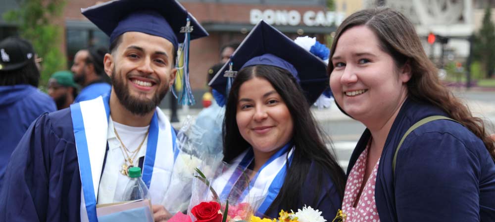 two graduates and a guest