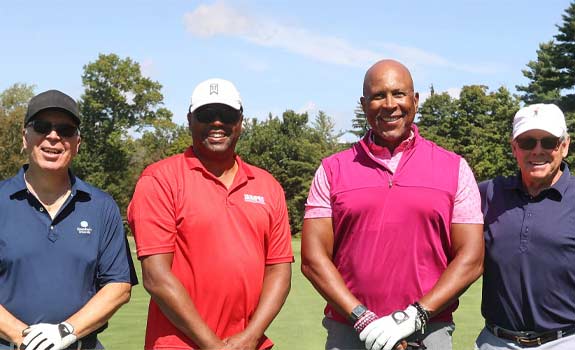 Group of 4 smiling golfers at last year’s tournament