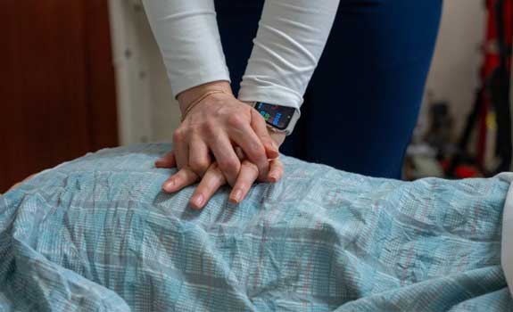 Student practicing chest compressions on a sim mannequin