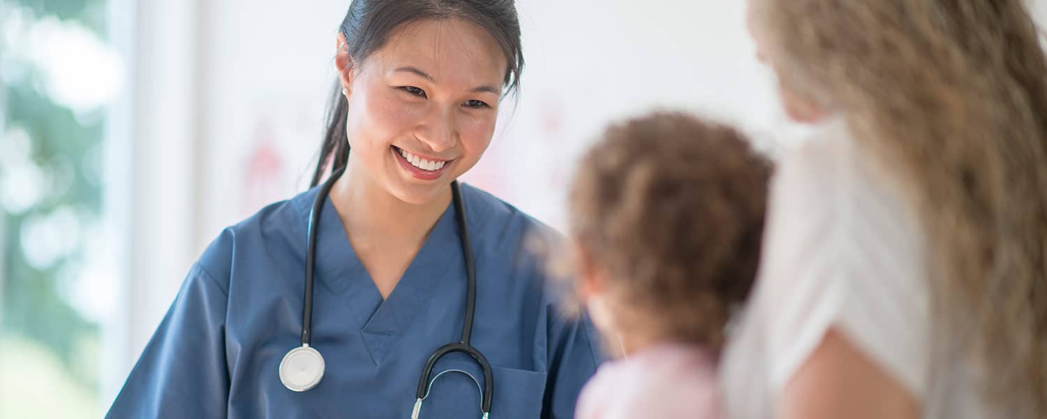 nurse speaking to a patient and their child