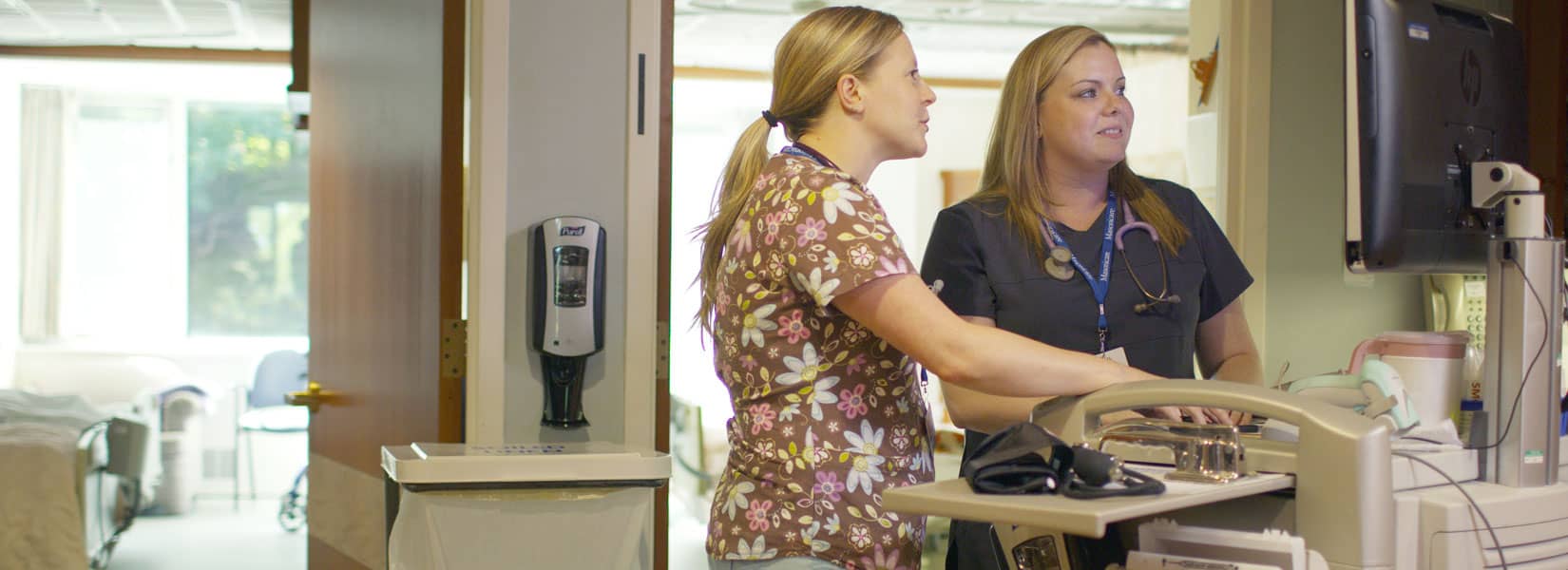 2 BSN students looking at a computer