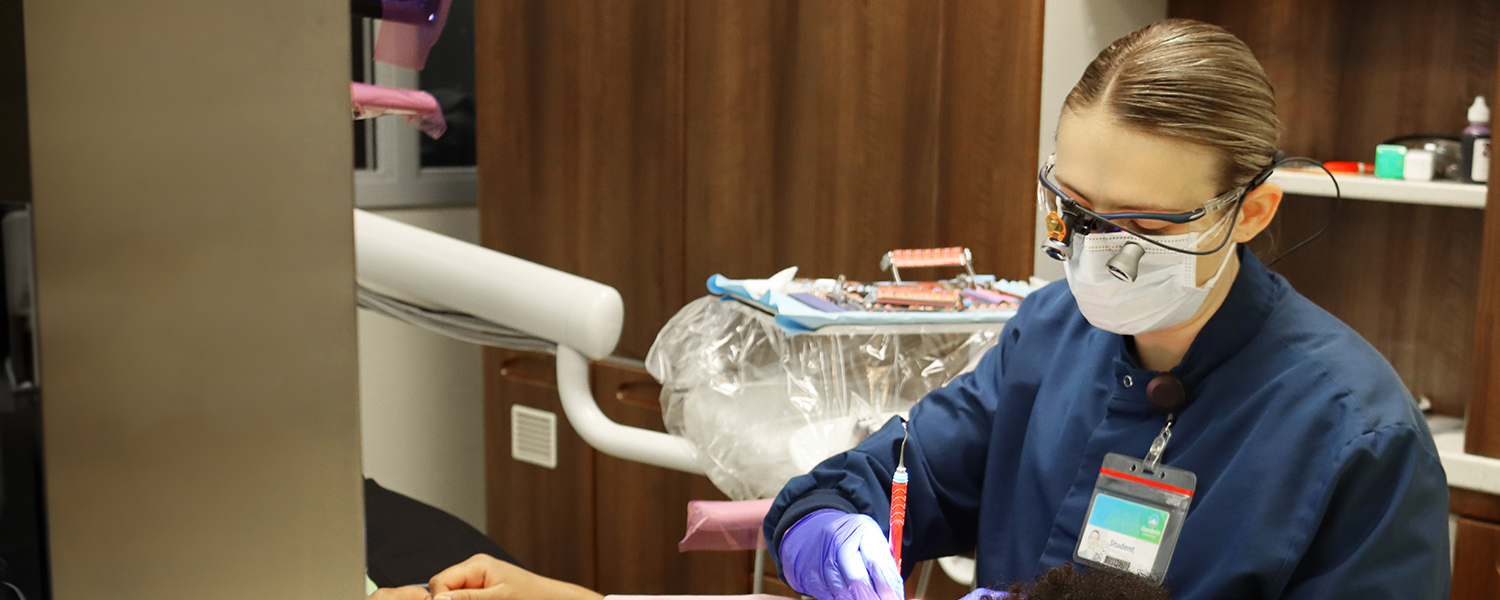 Dental Hygiene student working on a patient