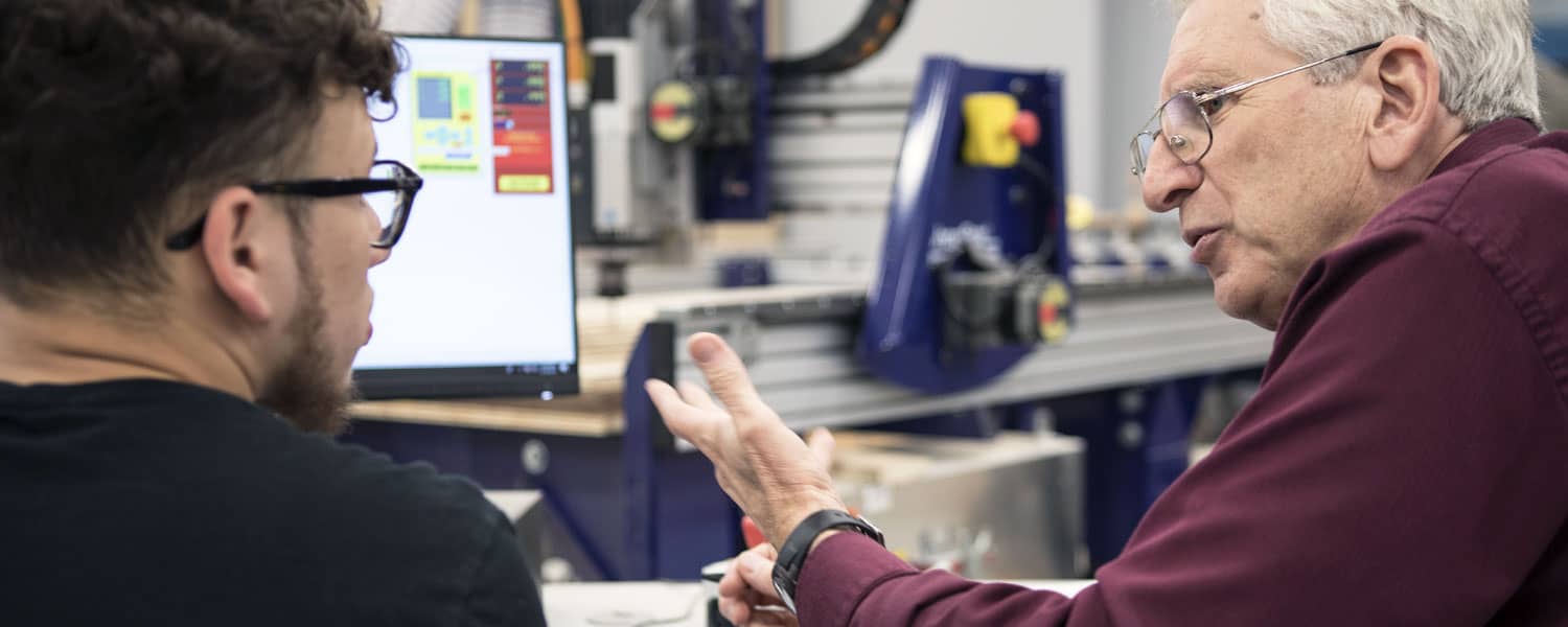 ECAMP professor explaining something to a student