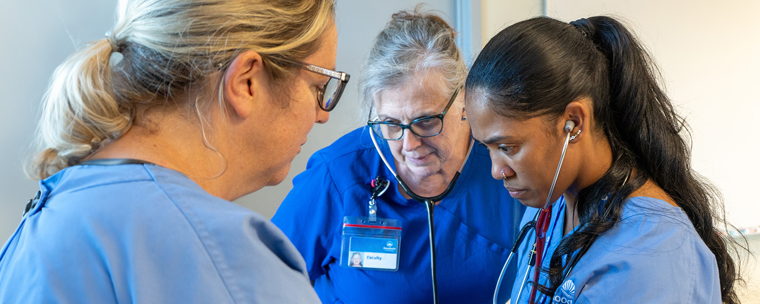 instructor overseeing a student take vitals