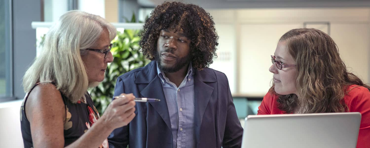 3 MSOL students looking at a laptop